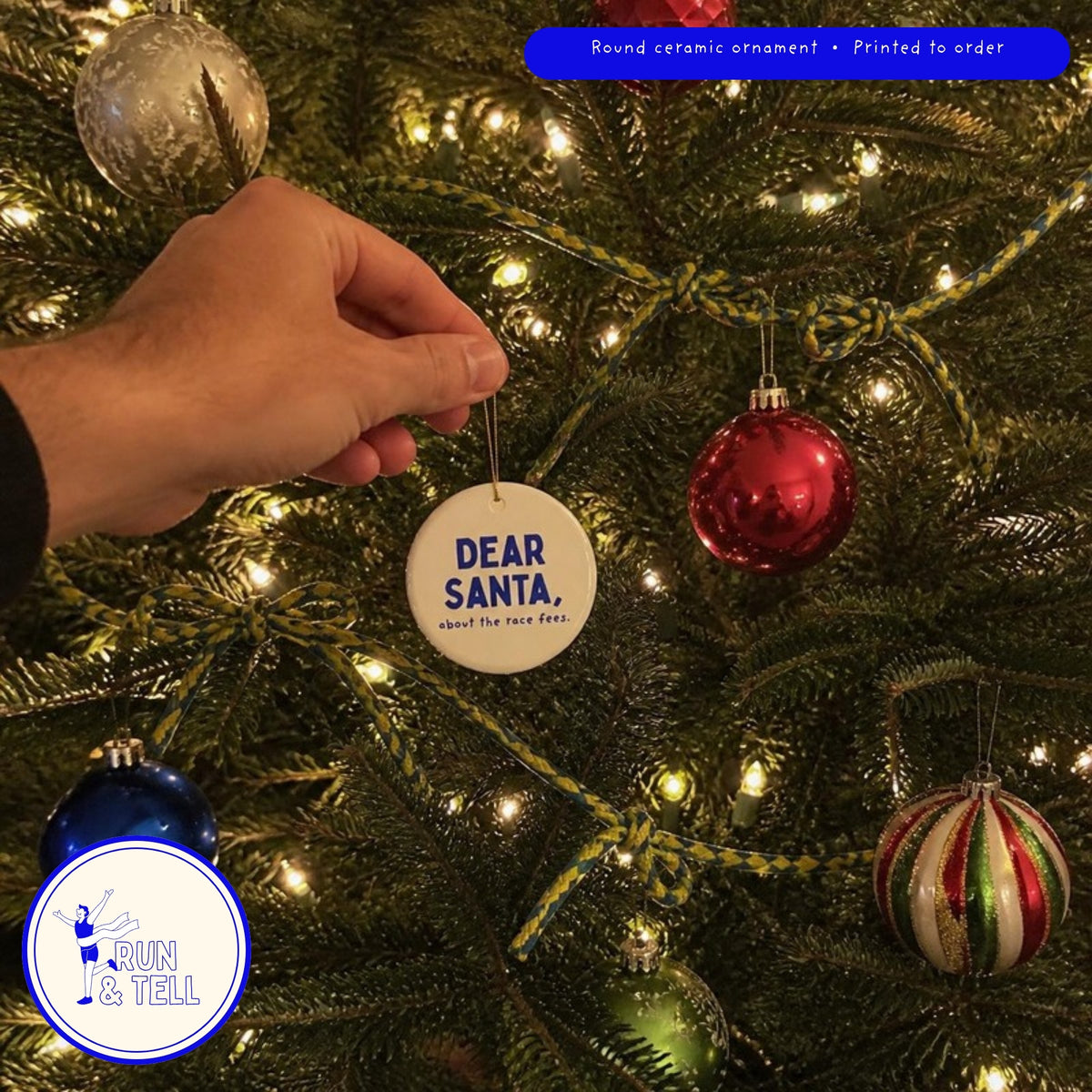 Dear Santa, About the Race Fees ornament hanging on a Christmas tree among glass baubles