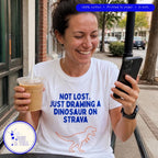 Not Lost. Just Drawing a Dinosaur on Strava running shirt at a cafe after a run, by Run & Tell