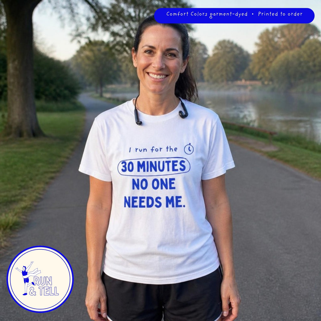 Runner mom smiling on a park path wearing the white I Run for the 30 Minutes No One Needs Me t-shirt