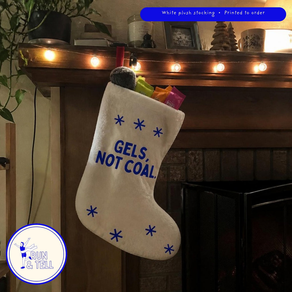 Gels, Not Coal runner stocking hanging on a mantel, filled with energy gels and running socks