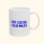 Hot Cocoa. Cold Miles. ceramic mug on a cream background