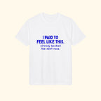 I Paid to Feel Like This white performance running t-shirt on a cream background