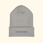 Cold Miles. Hot Takes. embroidered running beanie on a cream background