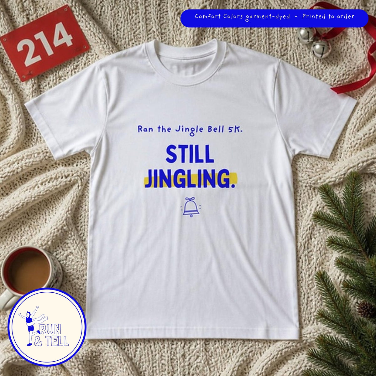 Still jingling Jingle Bell 5K tee flat lay on a knit blanket