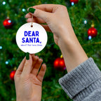 Dear Santa, About the Race Fees runner ornament held in front of a Christmas tree